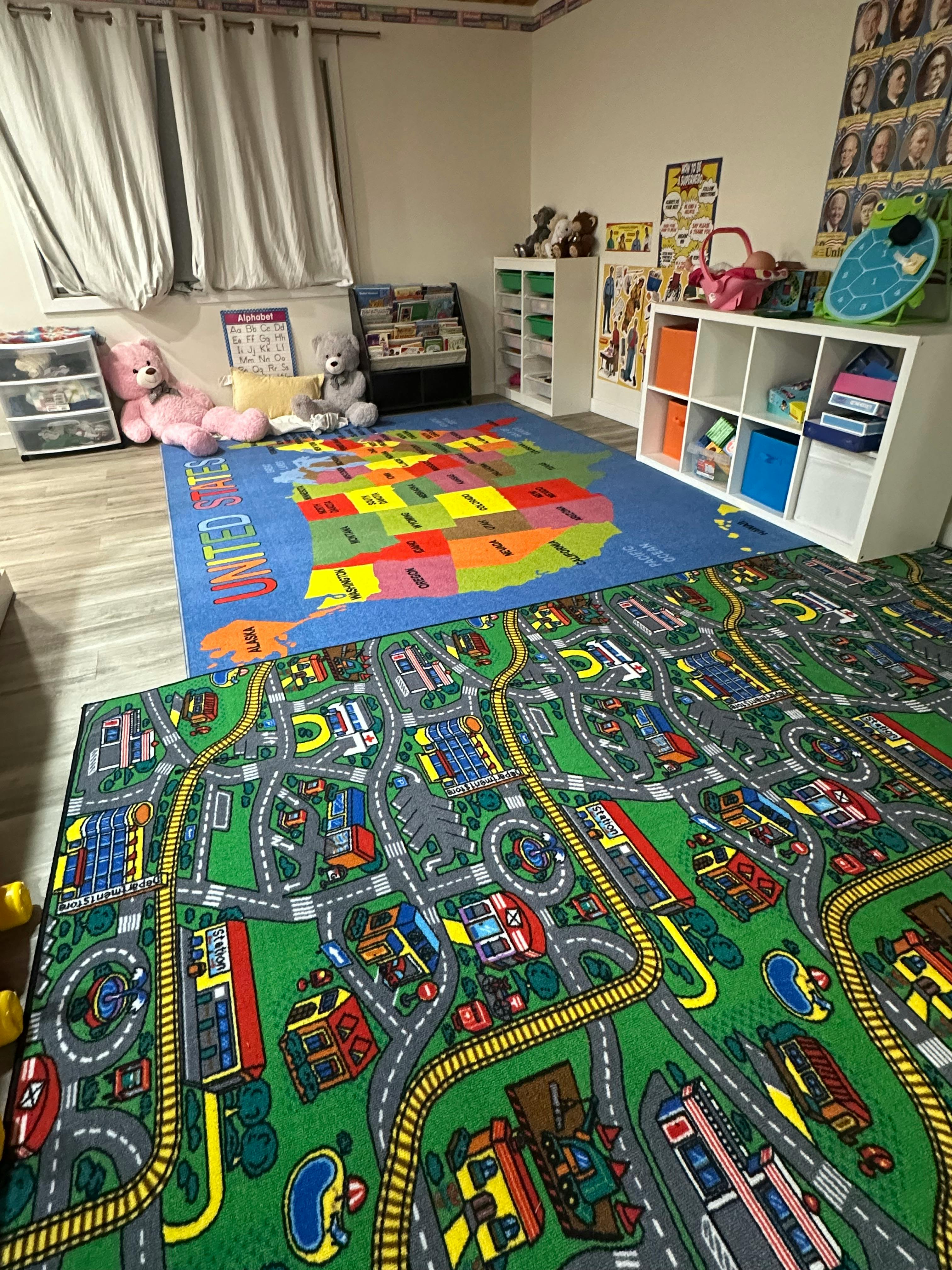 Playroom with two colorful rugs, one with a US map and another with a city road map