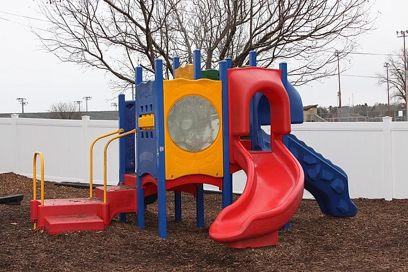 Colorful playground structure with slides and steps