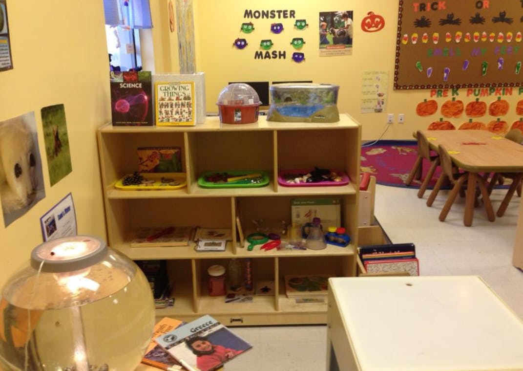 Classroom with shelves of learning materials and small tables