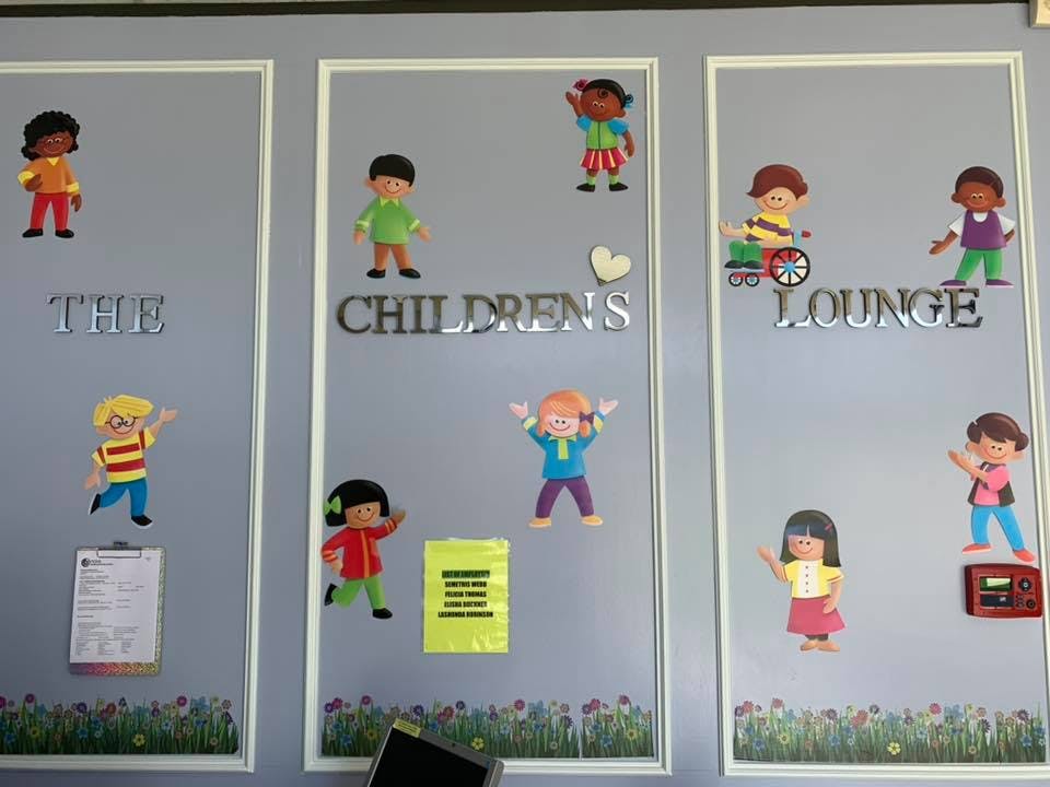Children's Lounge sign with cartoon children cutouts