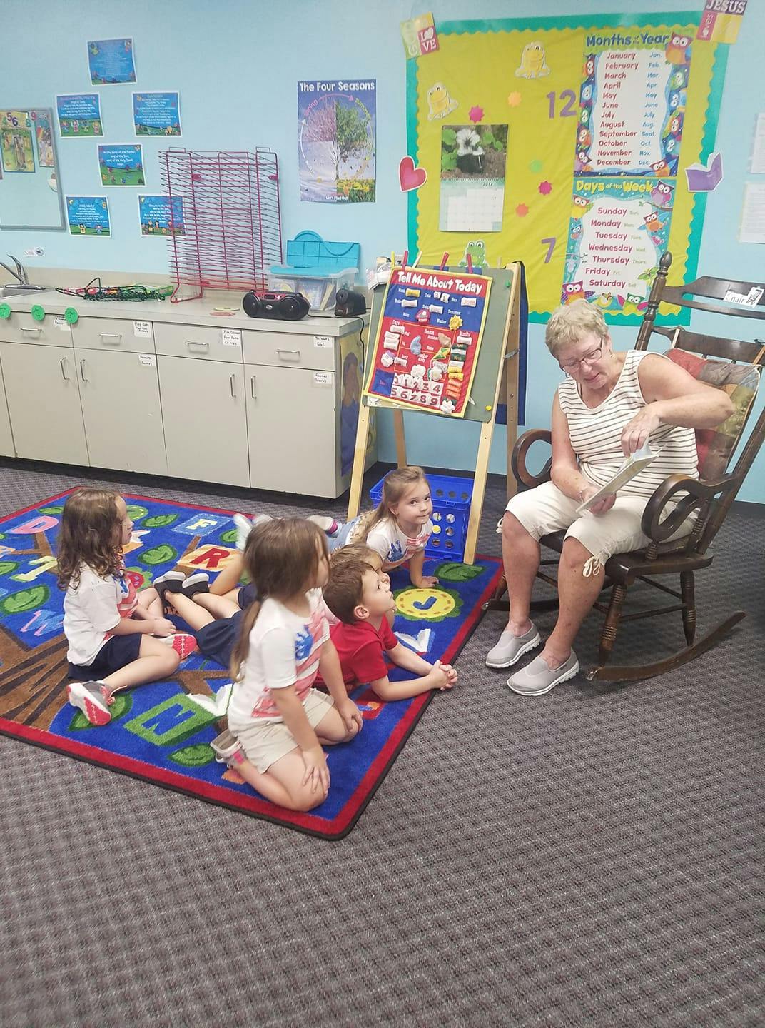 Adult reading to children in a classroom