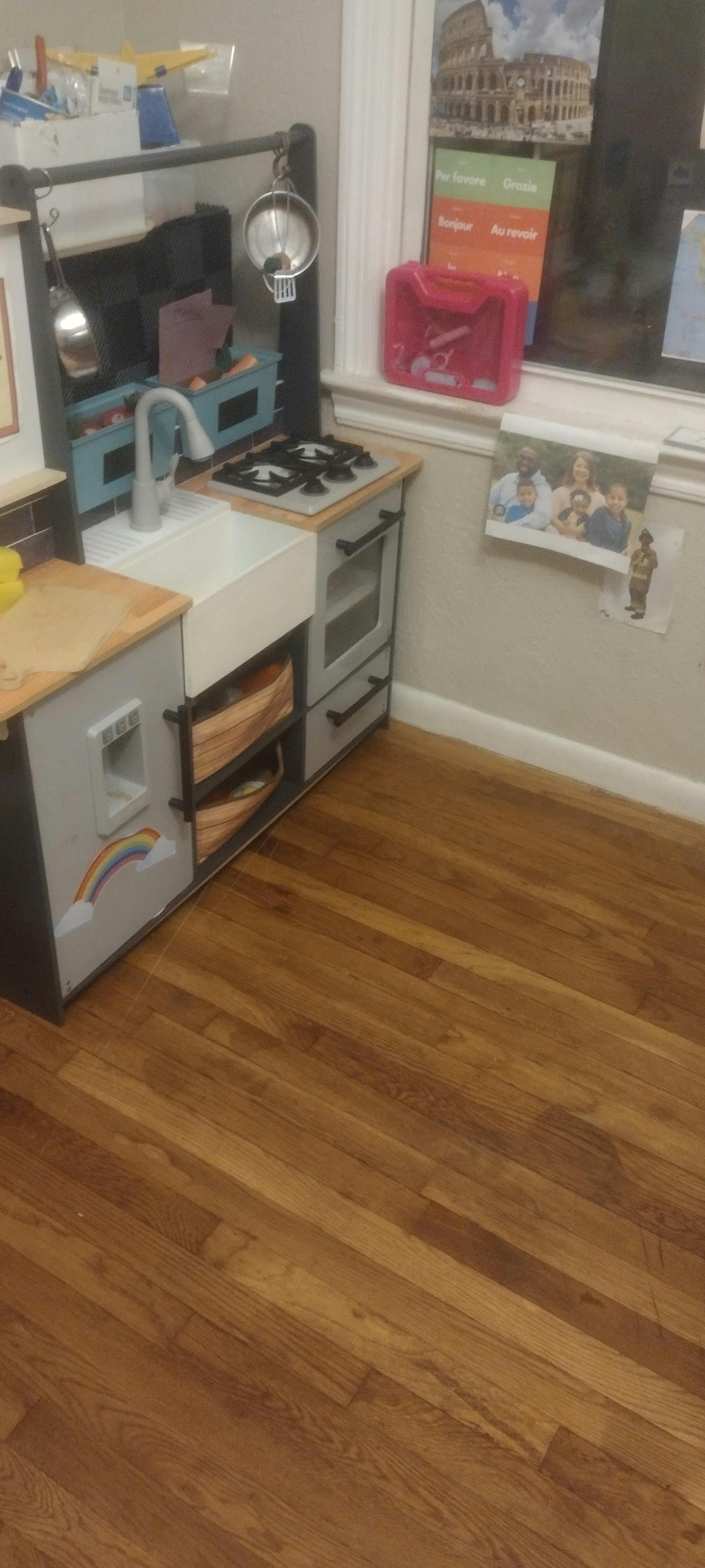 children's play kitchen with a sink, stove, and oven