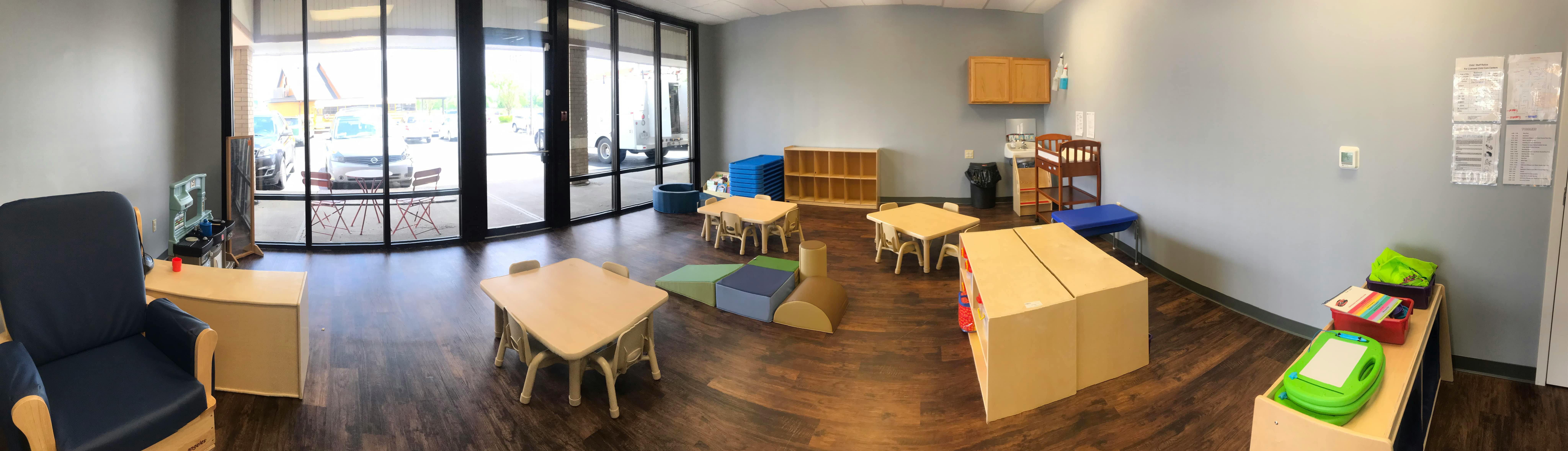 Empty classroom with small tables and chairs