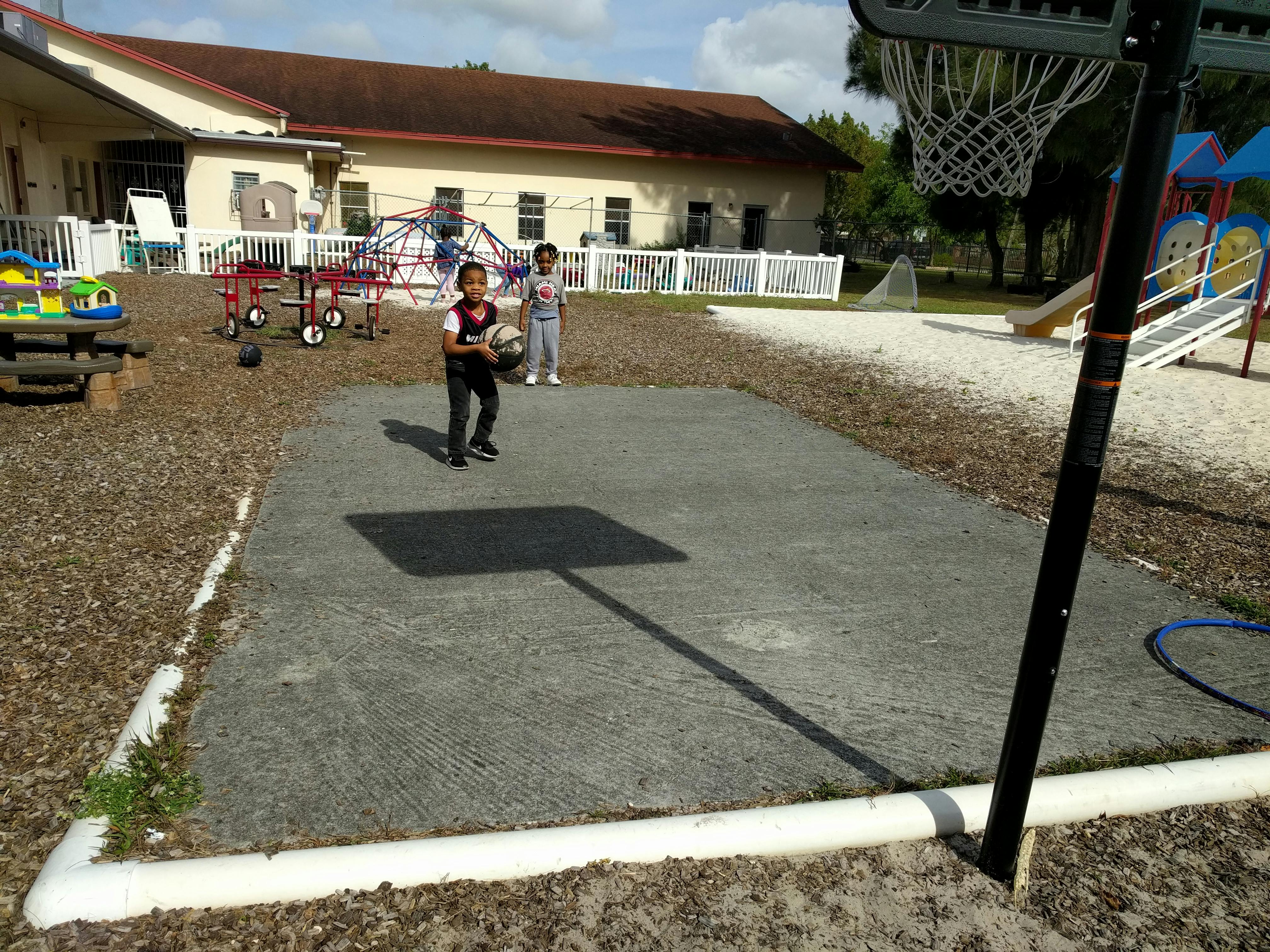 Two children on a basketball court