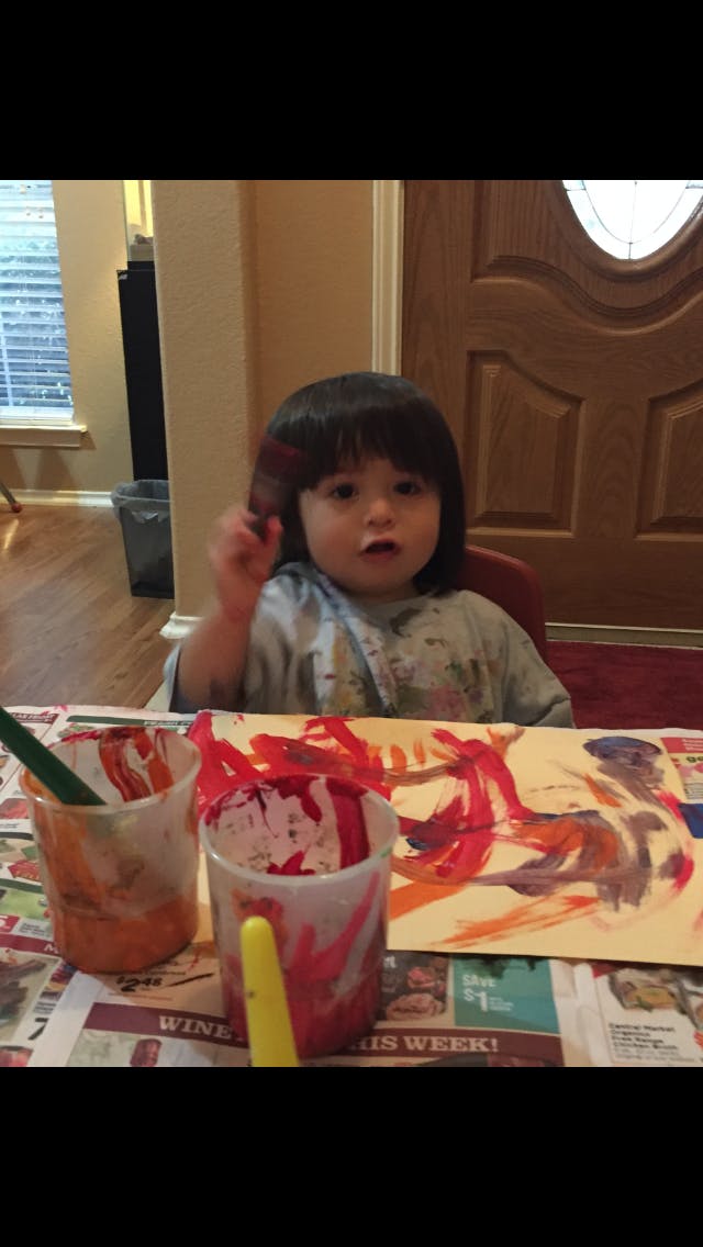 Child painting at a table