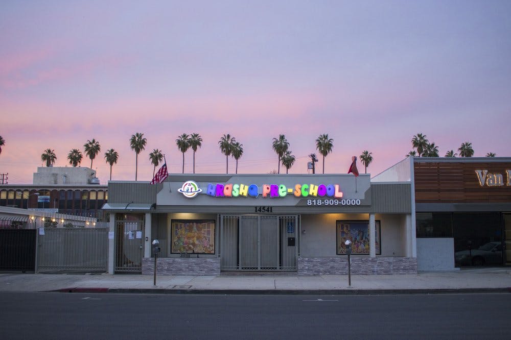 Building with a colorful sign that reads "KIDZ RUSH PRE-SCHOOL"