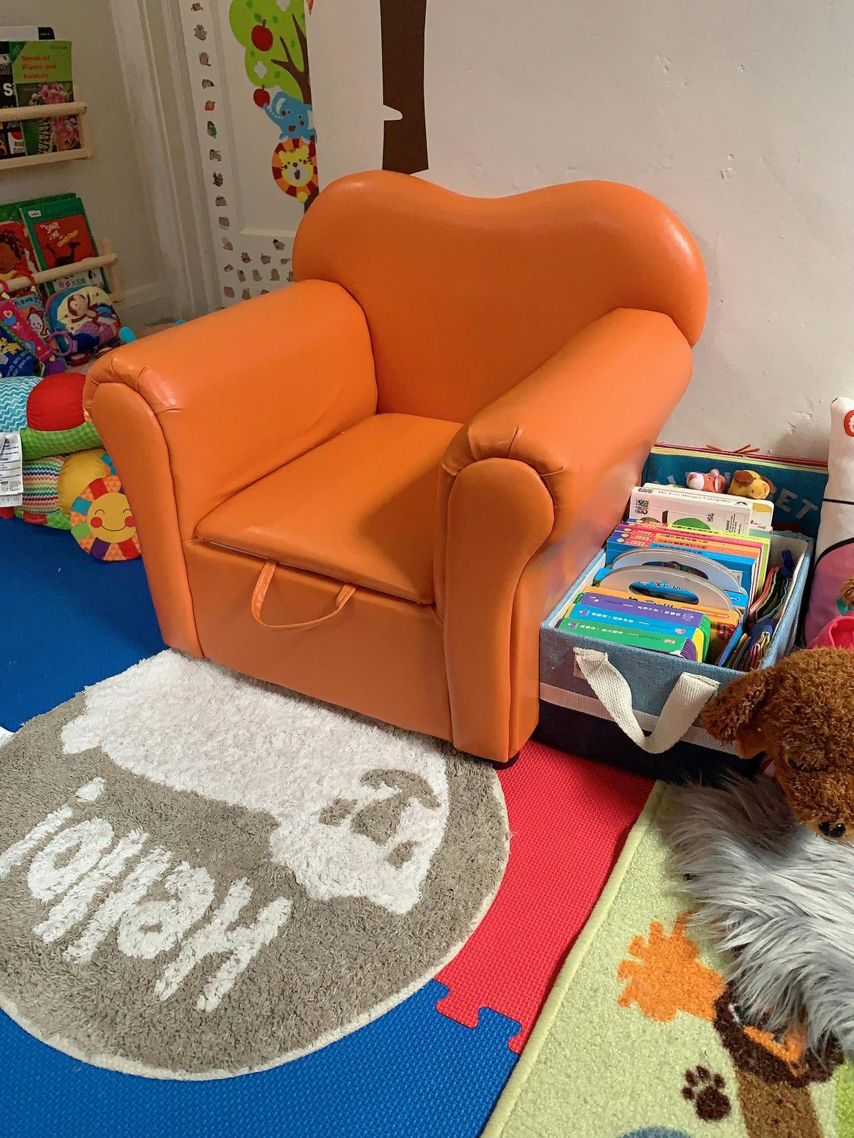 Orange child's armchair with a pull-out storage compartment