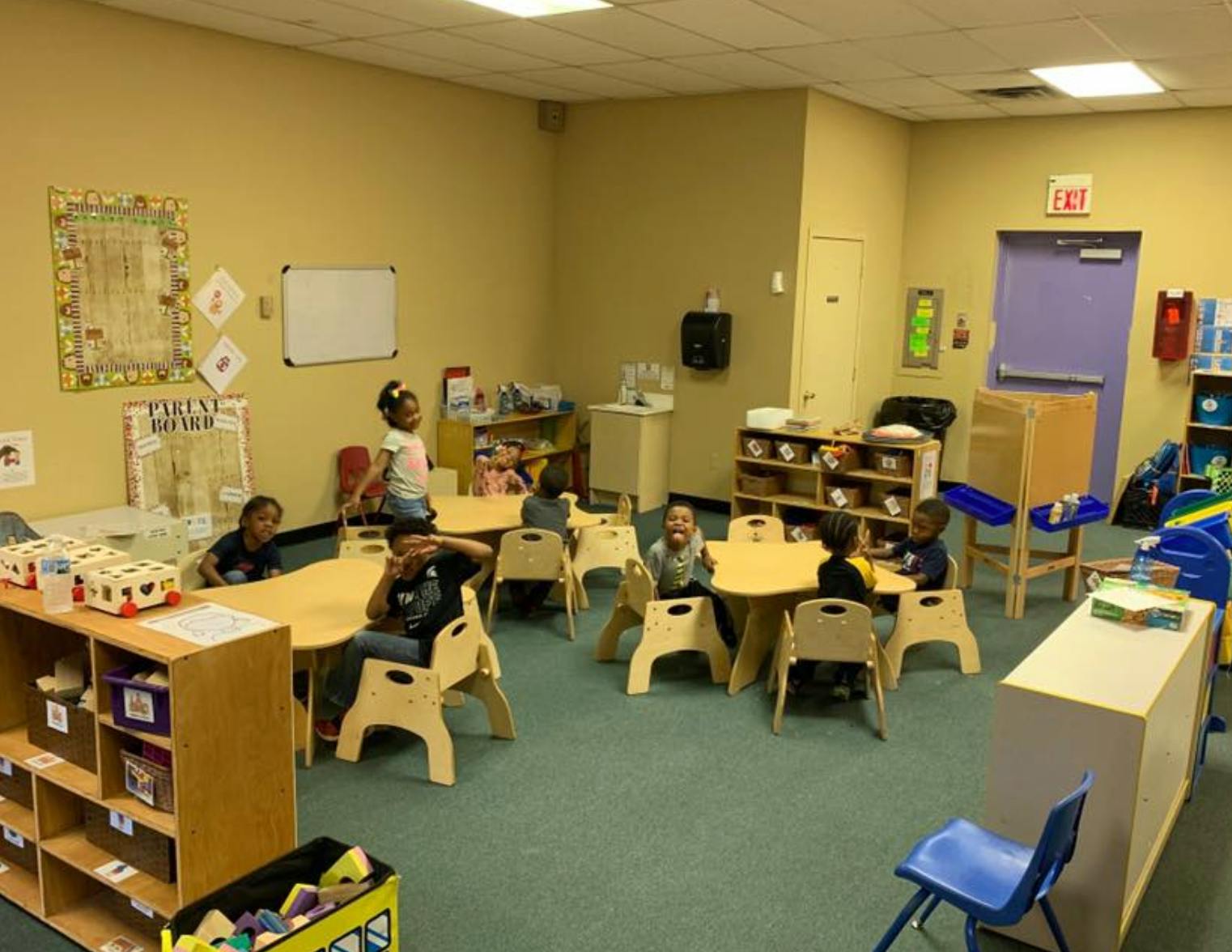 Children sitting at tables in a classroom