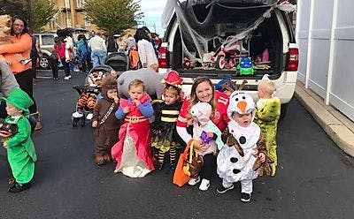 People and children in Halloween costumes