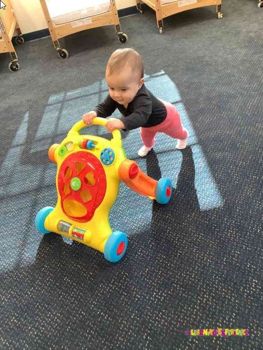 Child pushing a toy walker