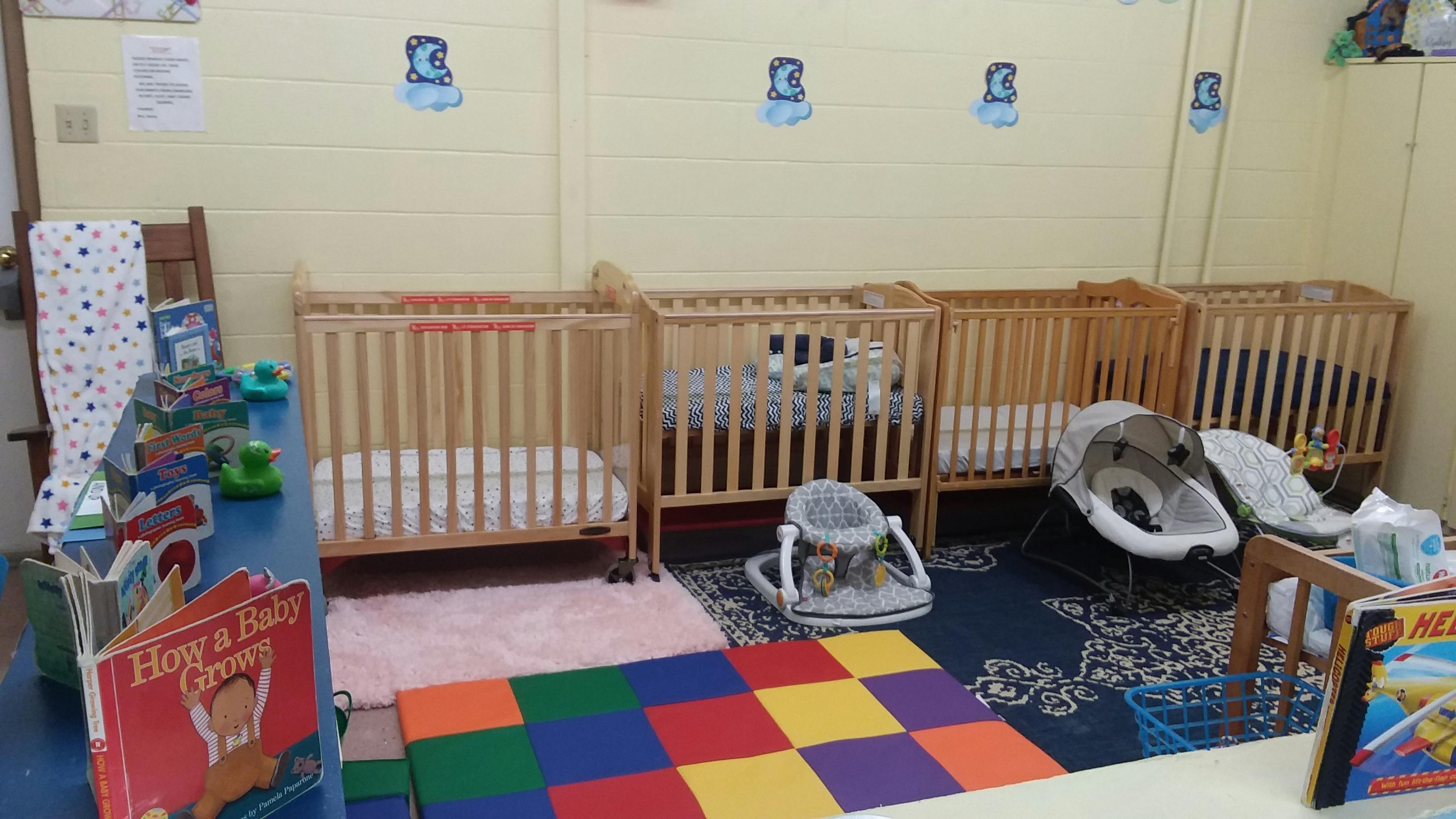 Cribs and play area in a childcare room