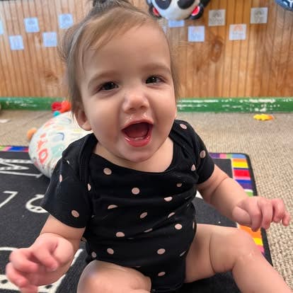 Child sitting on a floor mat