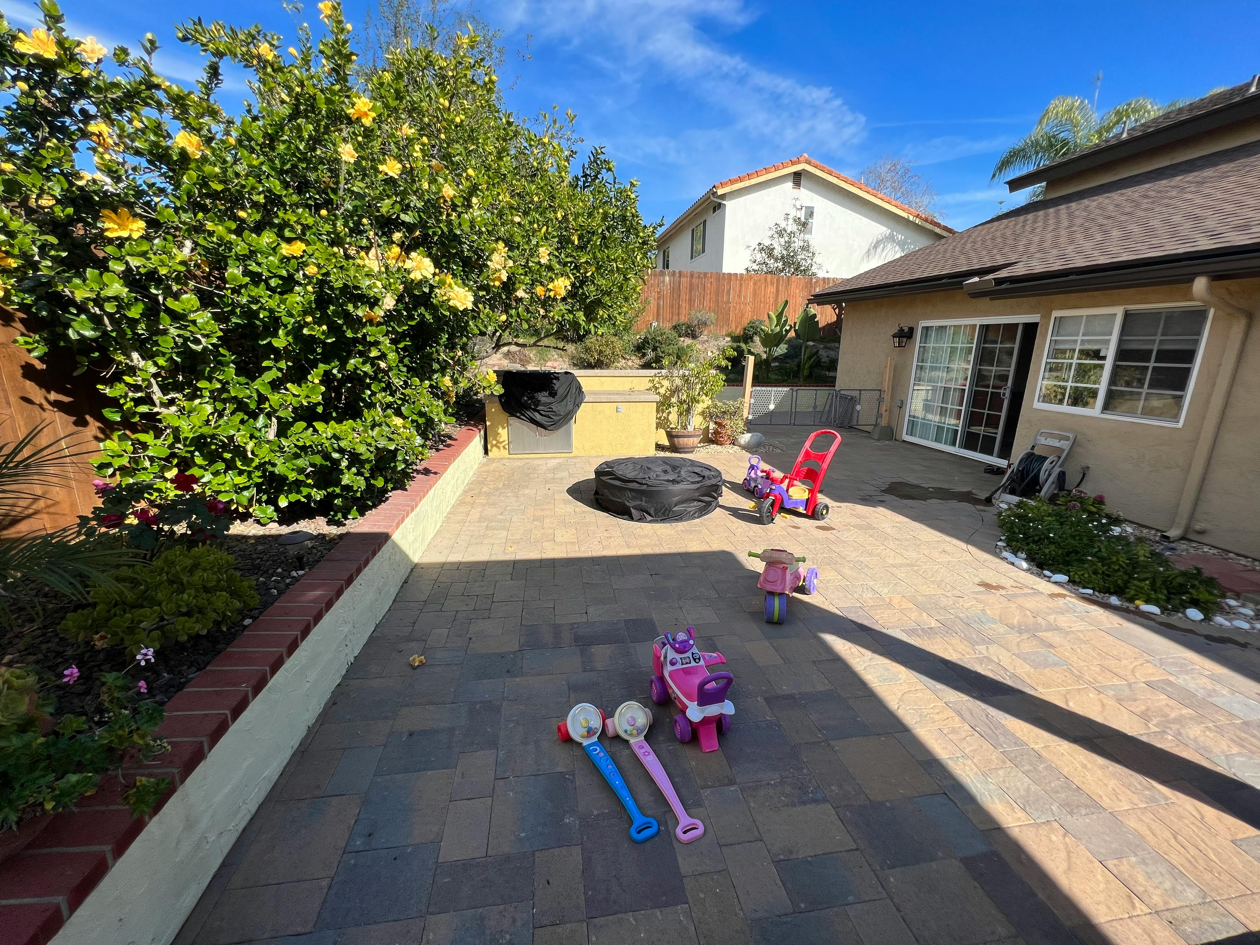 Patio with toys and a house in the background