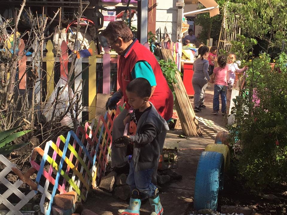 Adult and child looking at a colorful fence