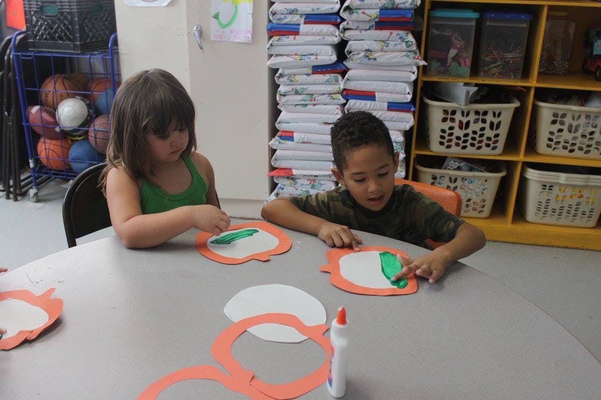 Two children doing crafts at a table