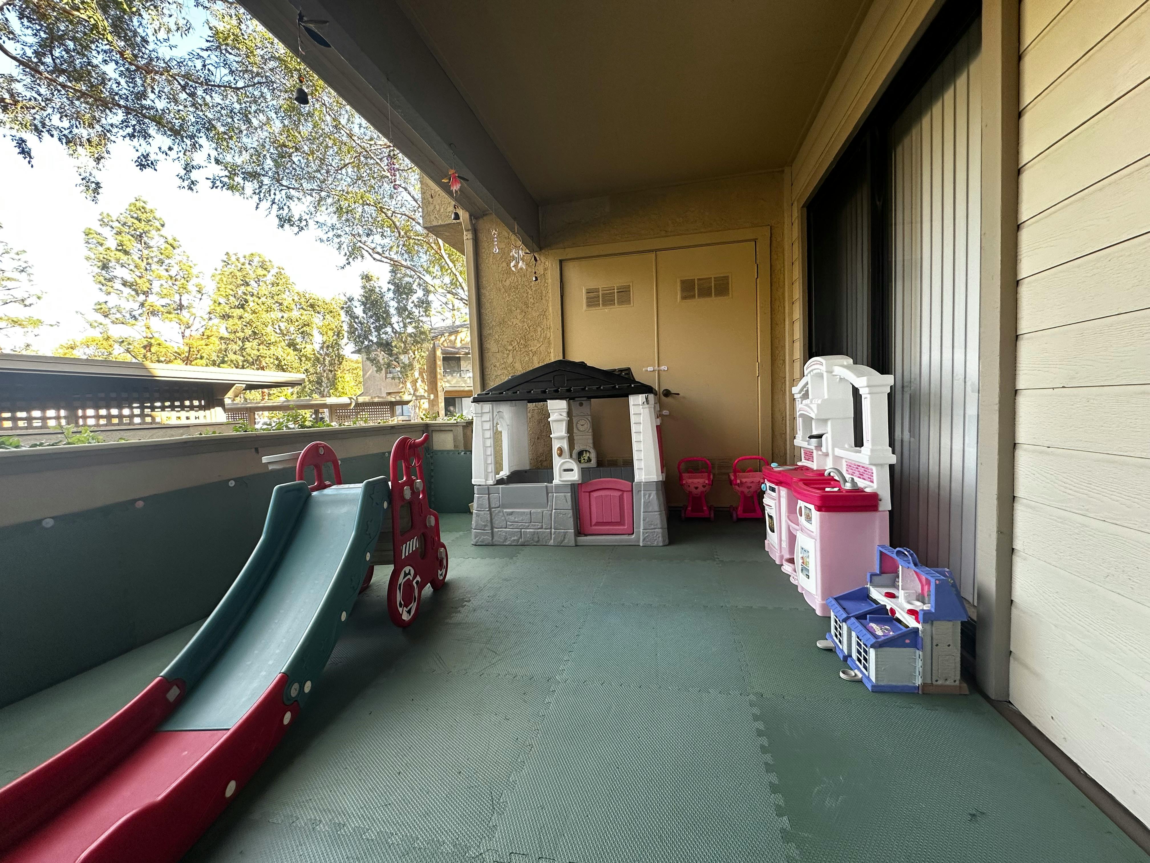 Children's play slide and playhouse on a patio