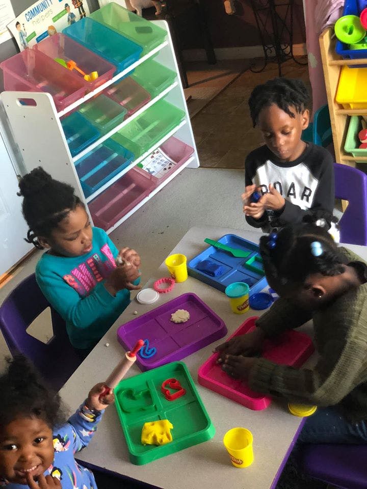 Children playing with modeling clay at a table