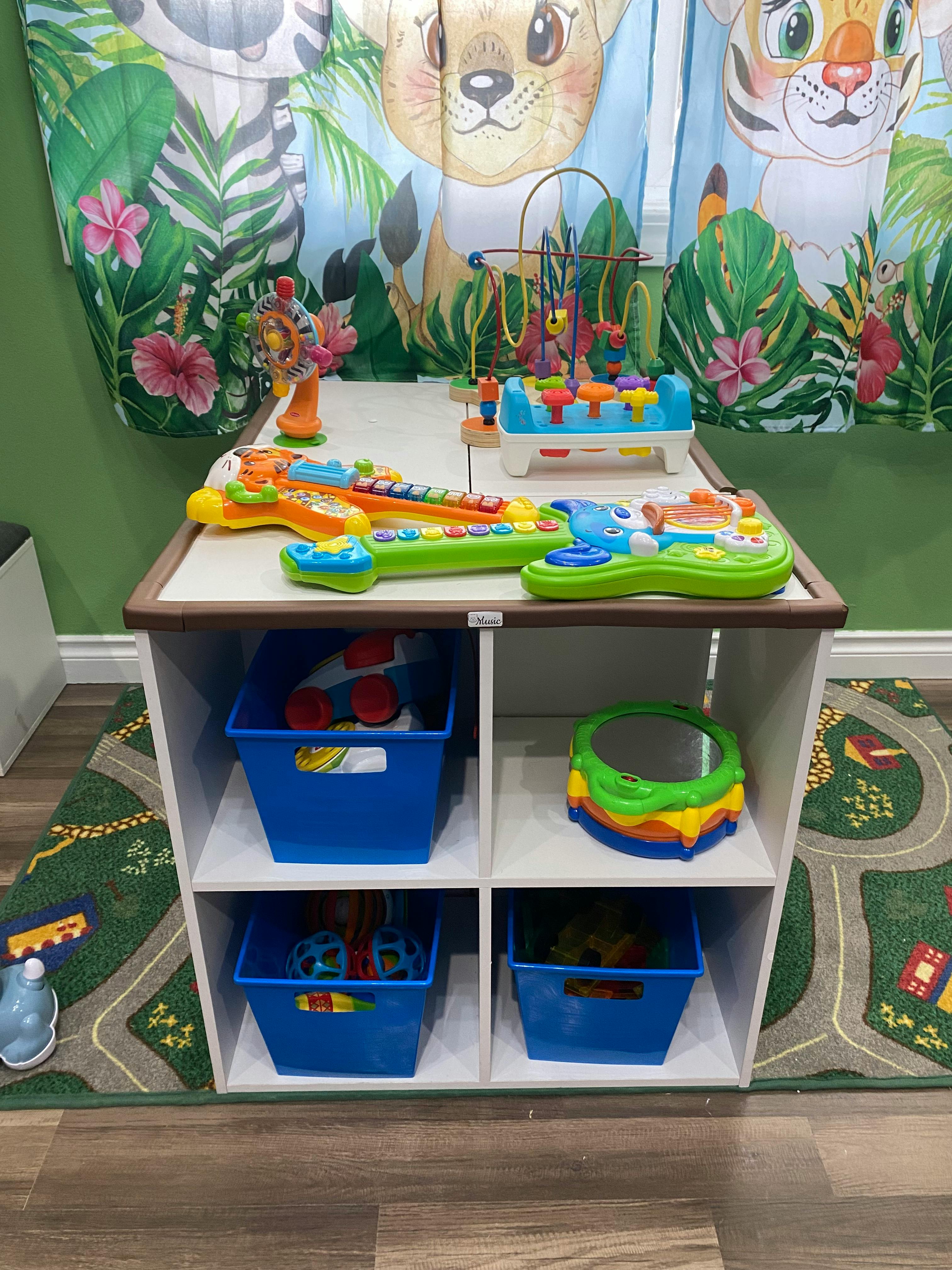 Children's toys on a table and in storage bins