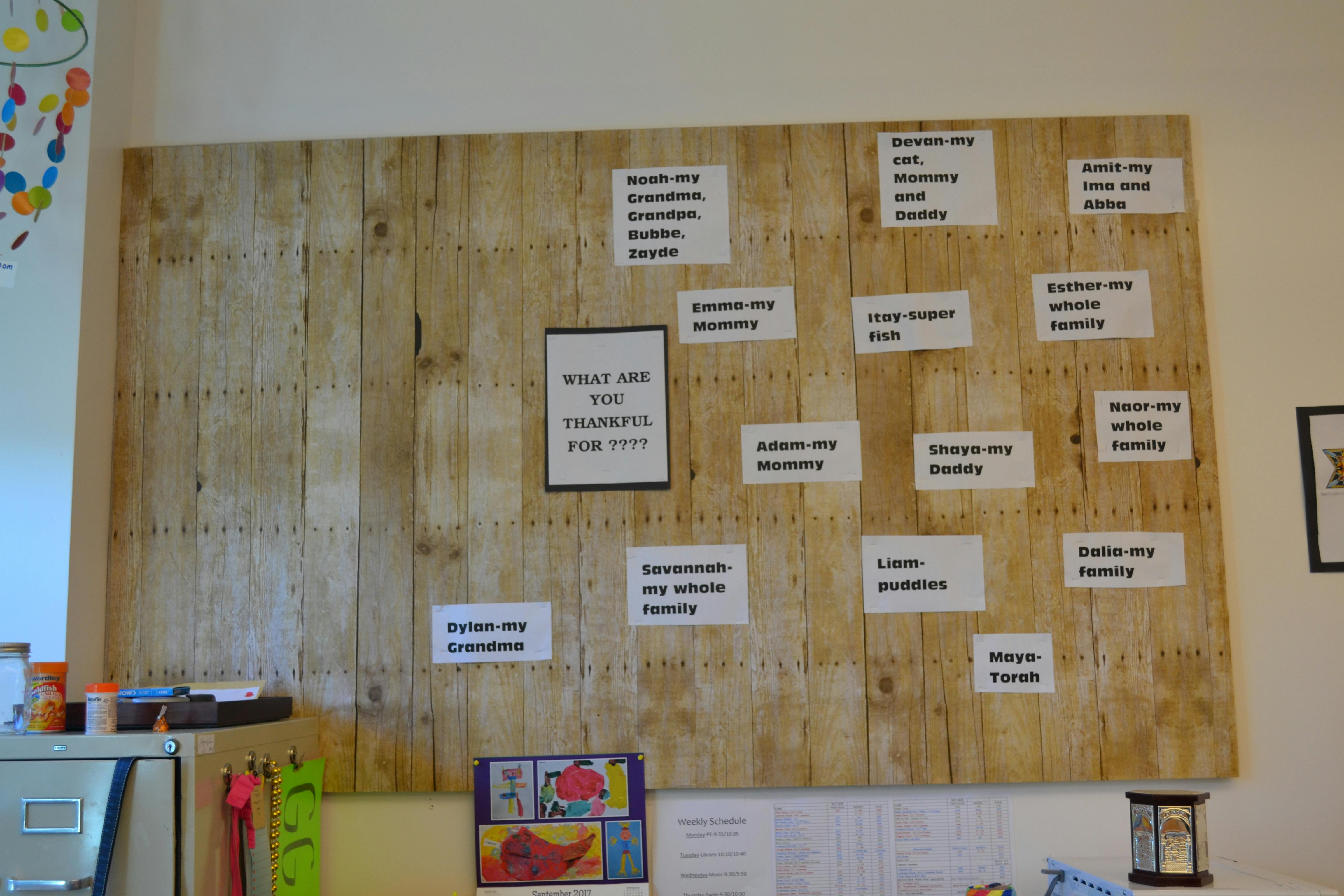 Wooden board with white cards containing text, "What are you thankful for?"