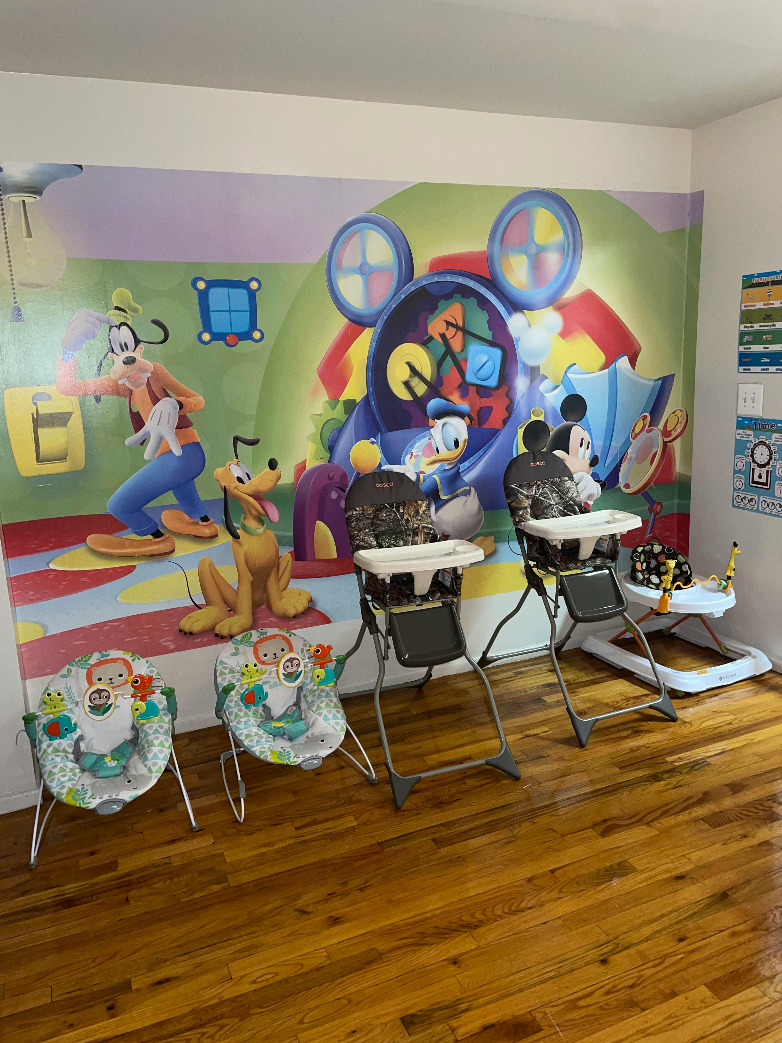 Nursery room with Disney mural and baby equipment