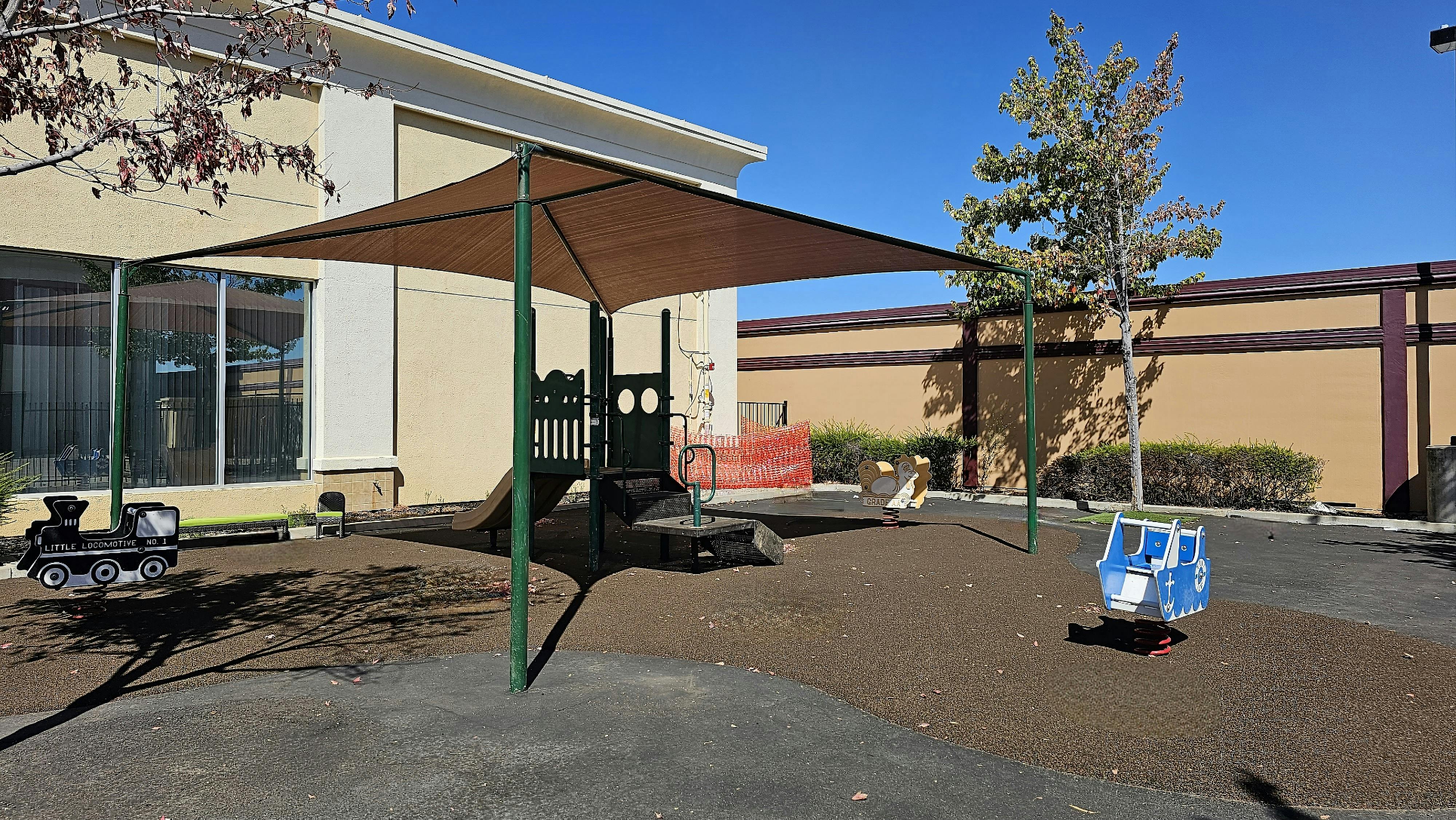 Playground with shade structure and play equipment