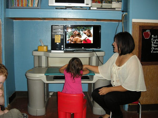 Person and child watching a screen