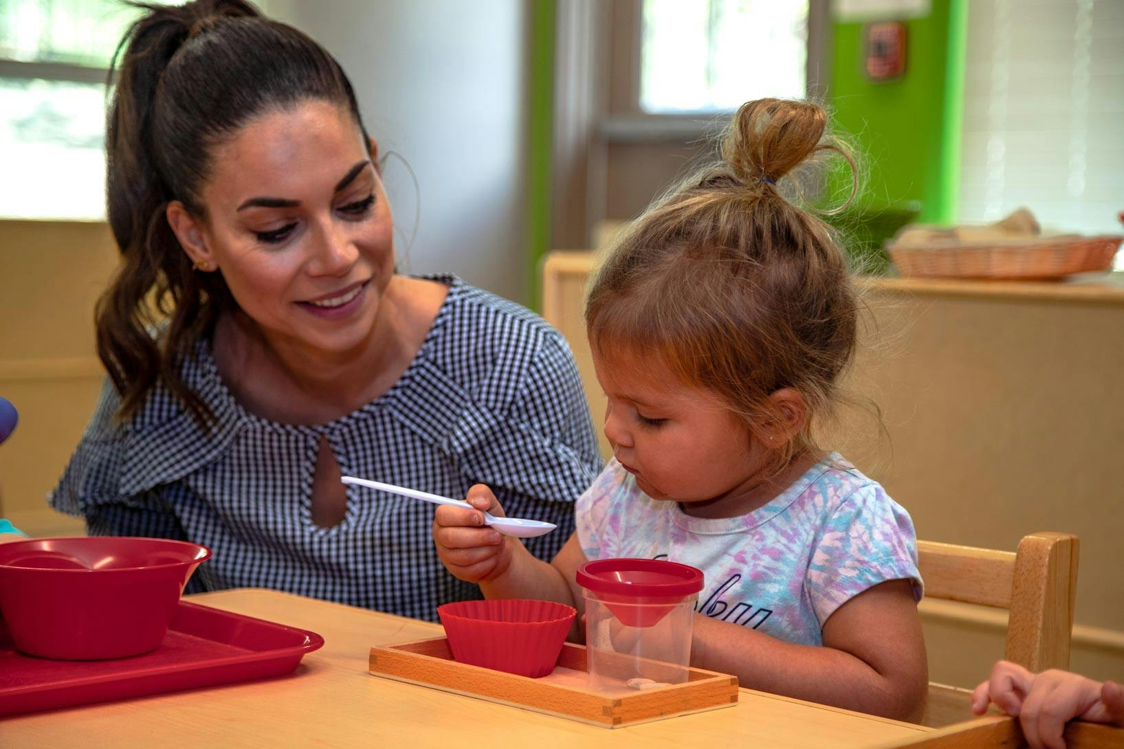 Person and child at a table with bowls and spoons