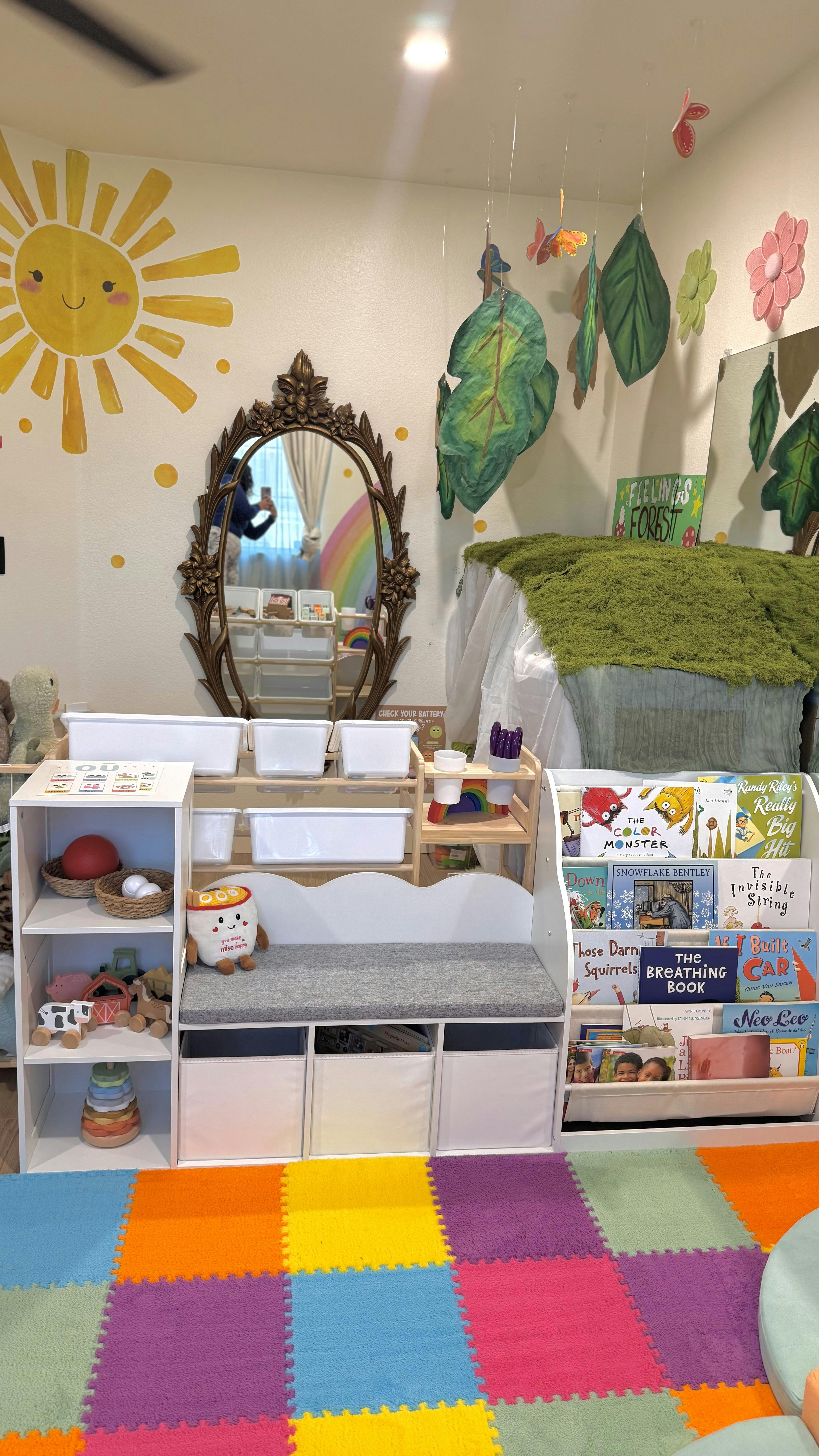 Playroom interior with children's bookshelves, toys, and colorful floor mats