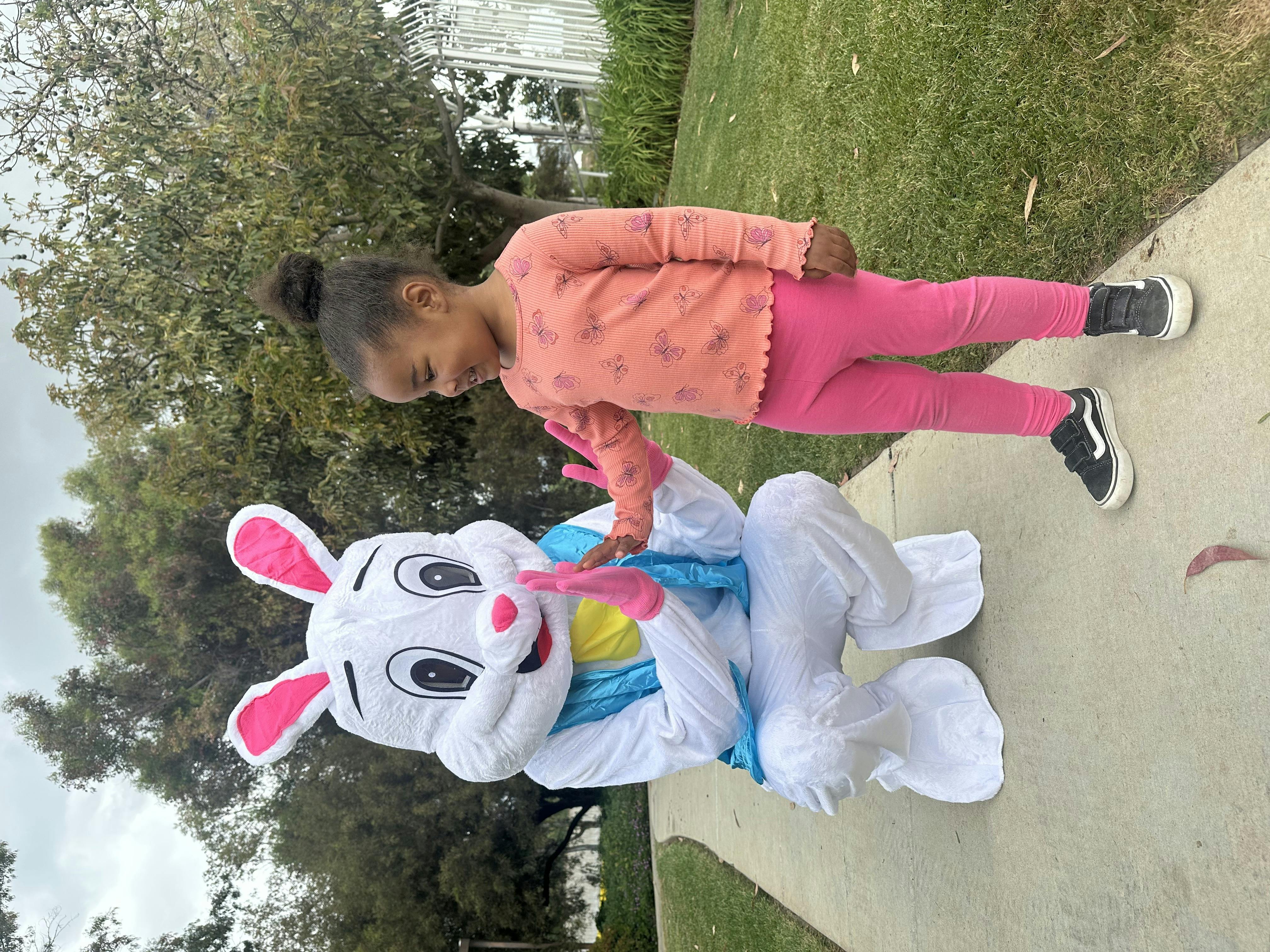 Child interacting with a person in a bunny costume
