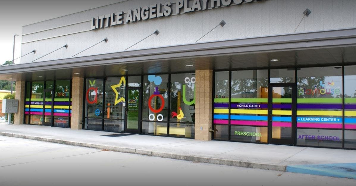 Storefront with "Little Angels Play" sign and colorful window decorations
