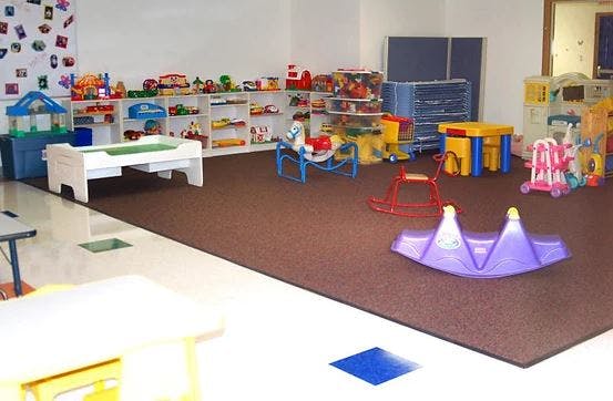 Playroom with toys, shelves, and play equipment
