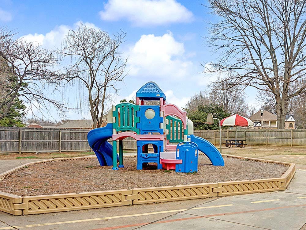 Colorful playground structure with slides and climbing areas
