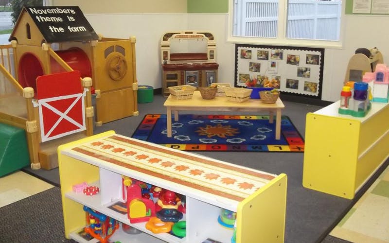 Classroom with play structures, toys, and small tables