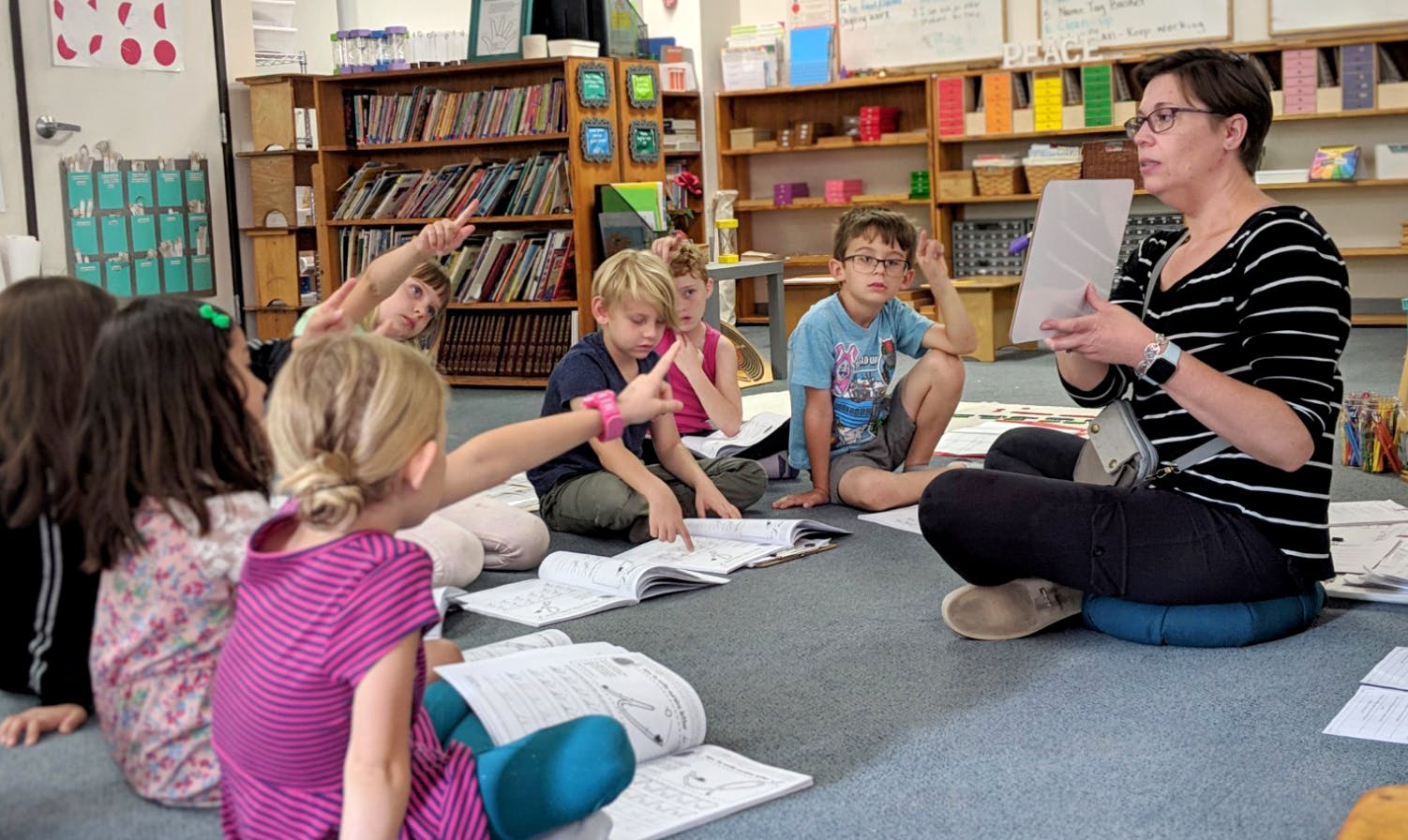 Adult reading to children sitting on the floor in a classroom