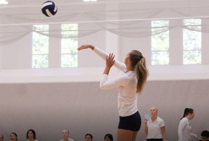 Person in athletic wear hitting a volleyball