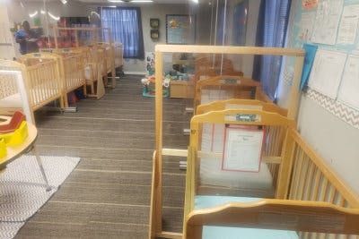Multiple wooden cribs in a room