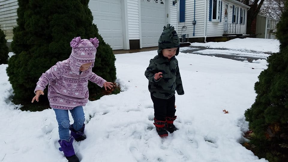 Two children playing in snow