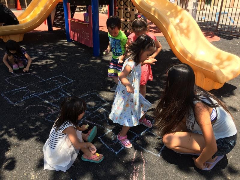 Children playing hopscotch on a playground