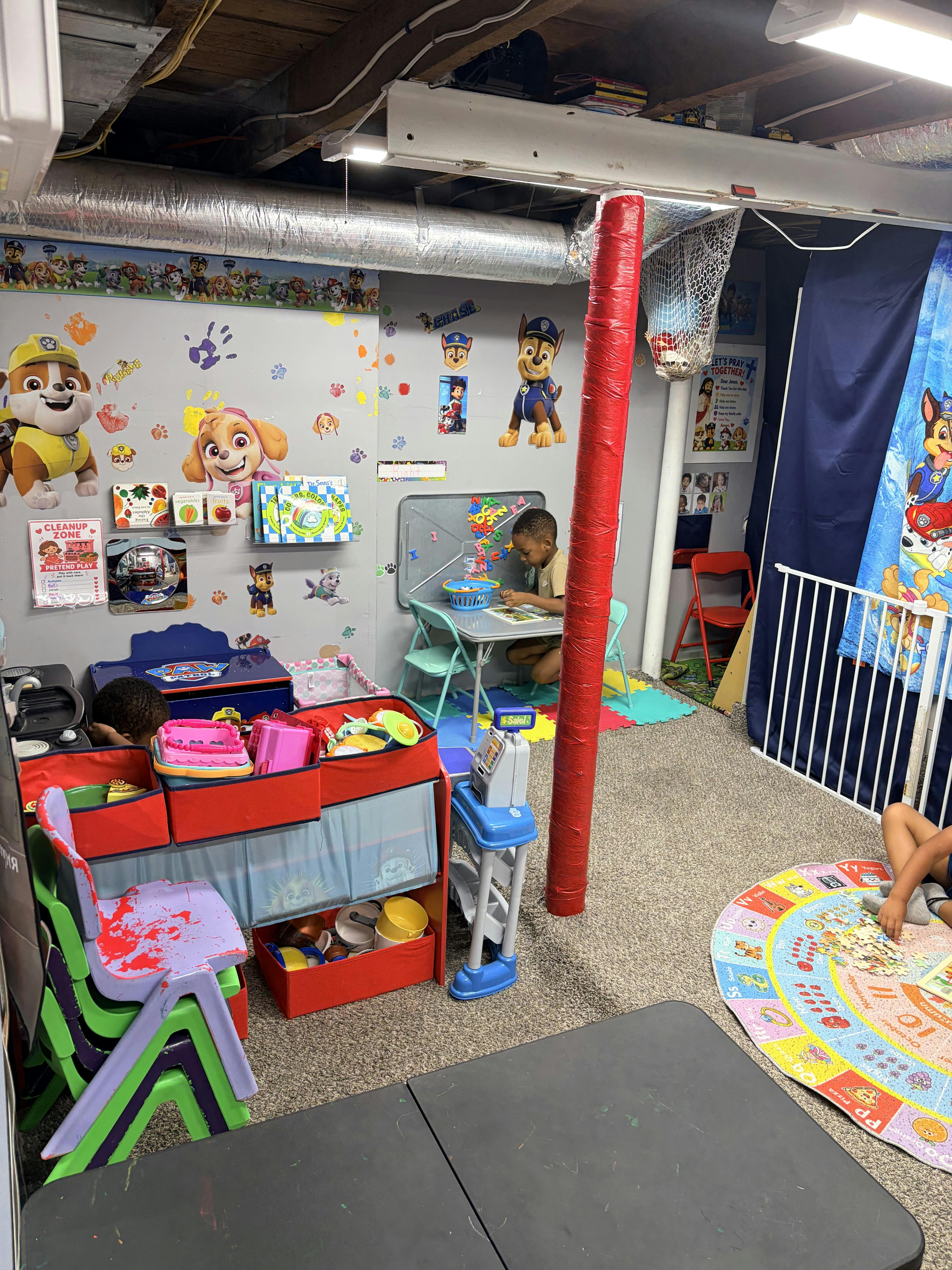 Children playing in a themed room with toys and educational mats