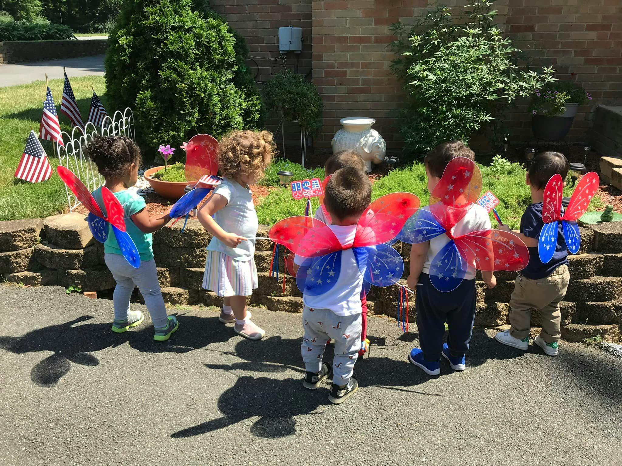Children wearing red, white, and blue butterfly wings