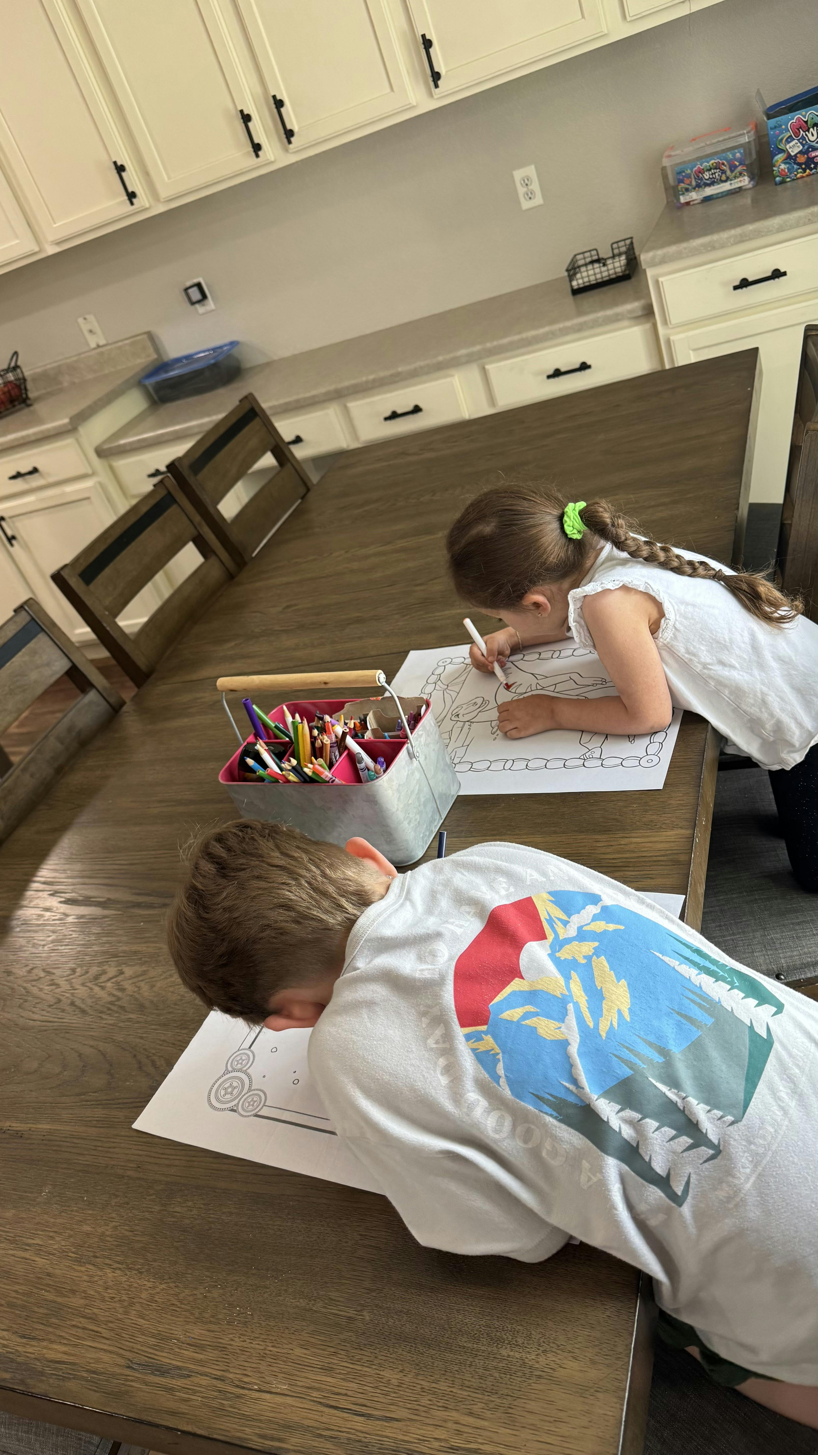Two children coloring at a table