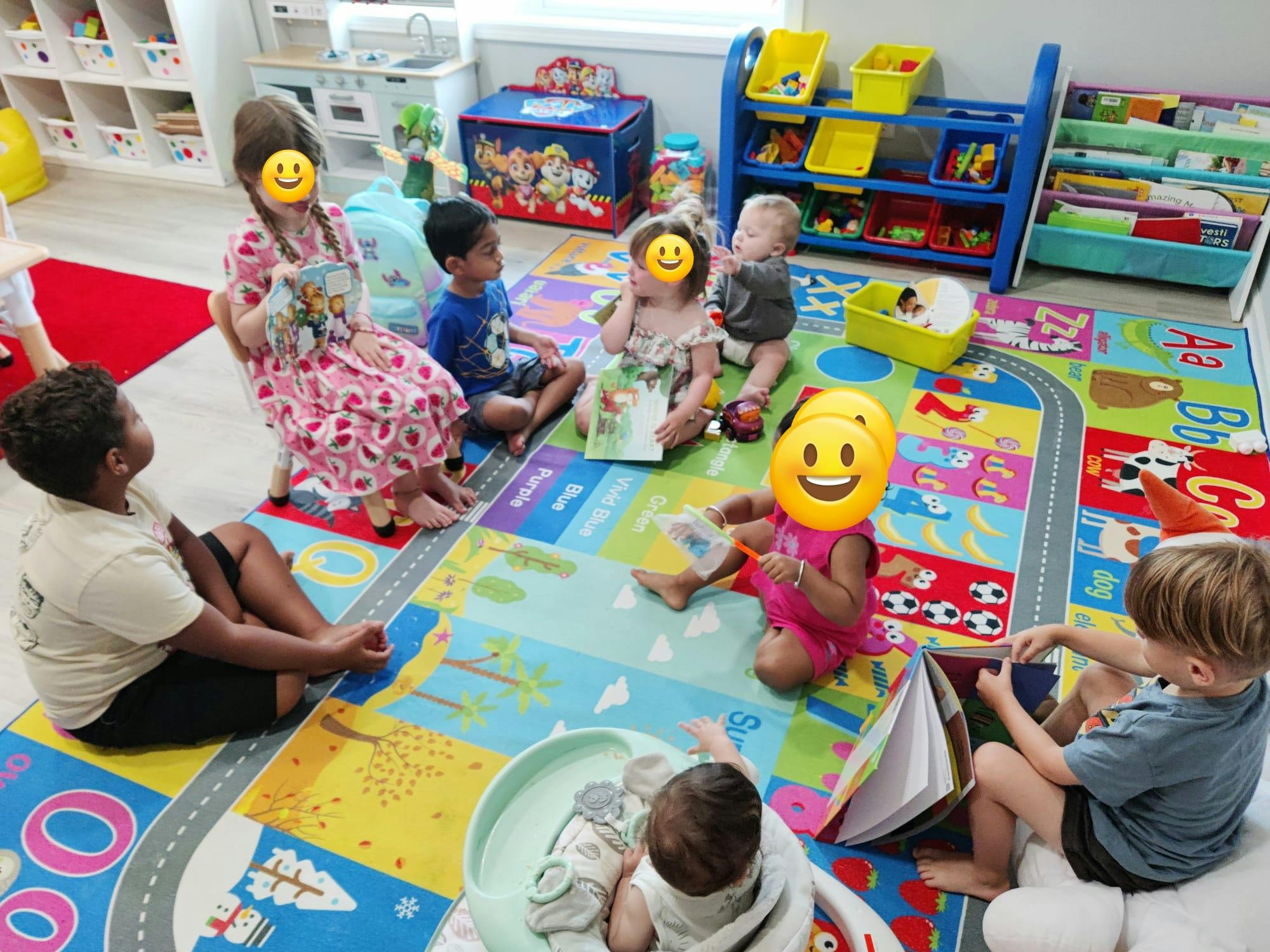 Group of children playing and reading books on a colorful classroom rug