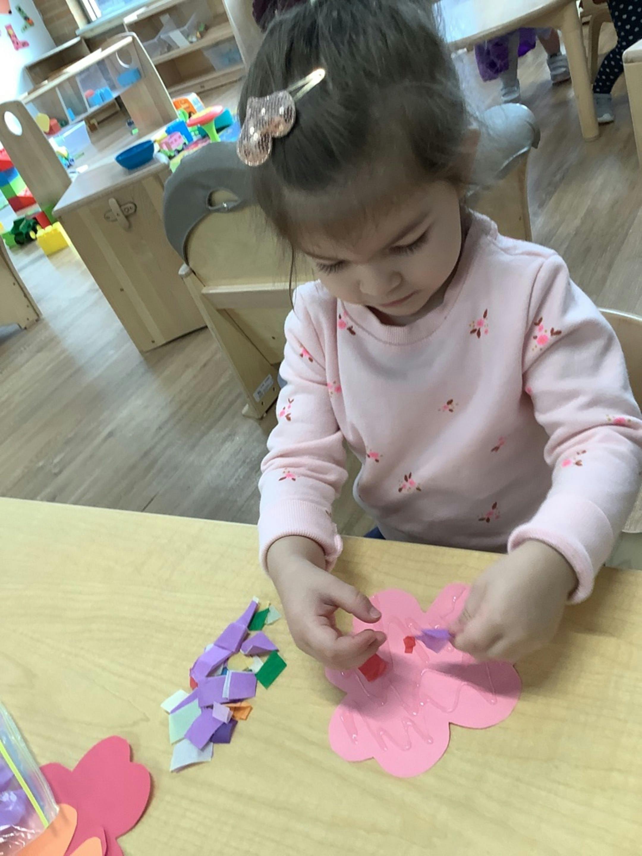 Child doing a craft at a table