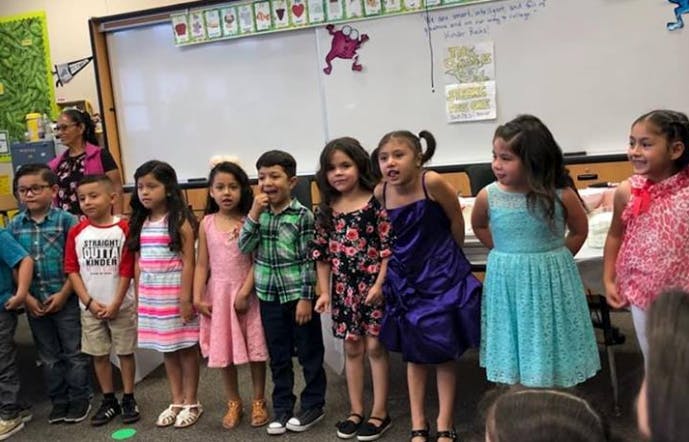 Children standing in a line in a classroom