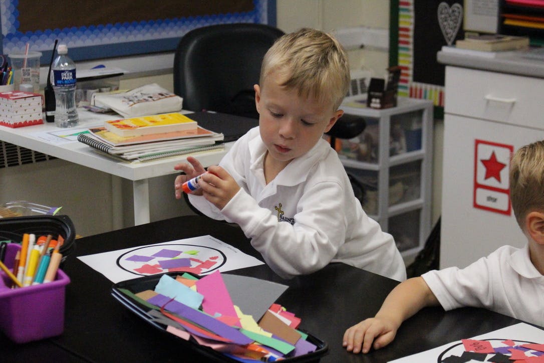 Child doing an art project at a table