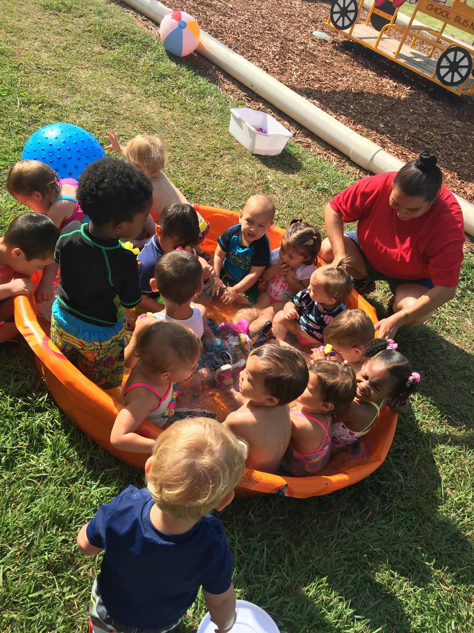 Person and children in an inflatable pool