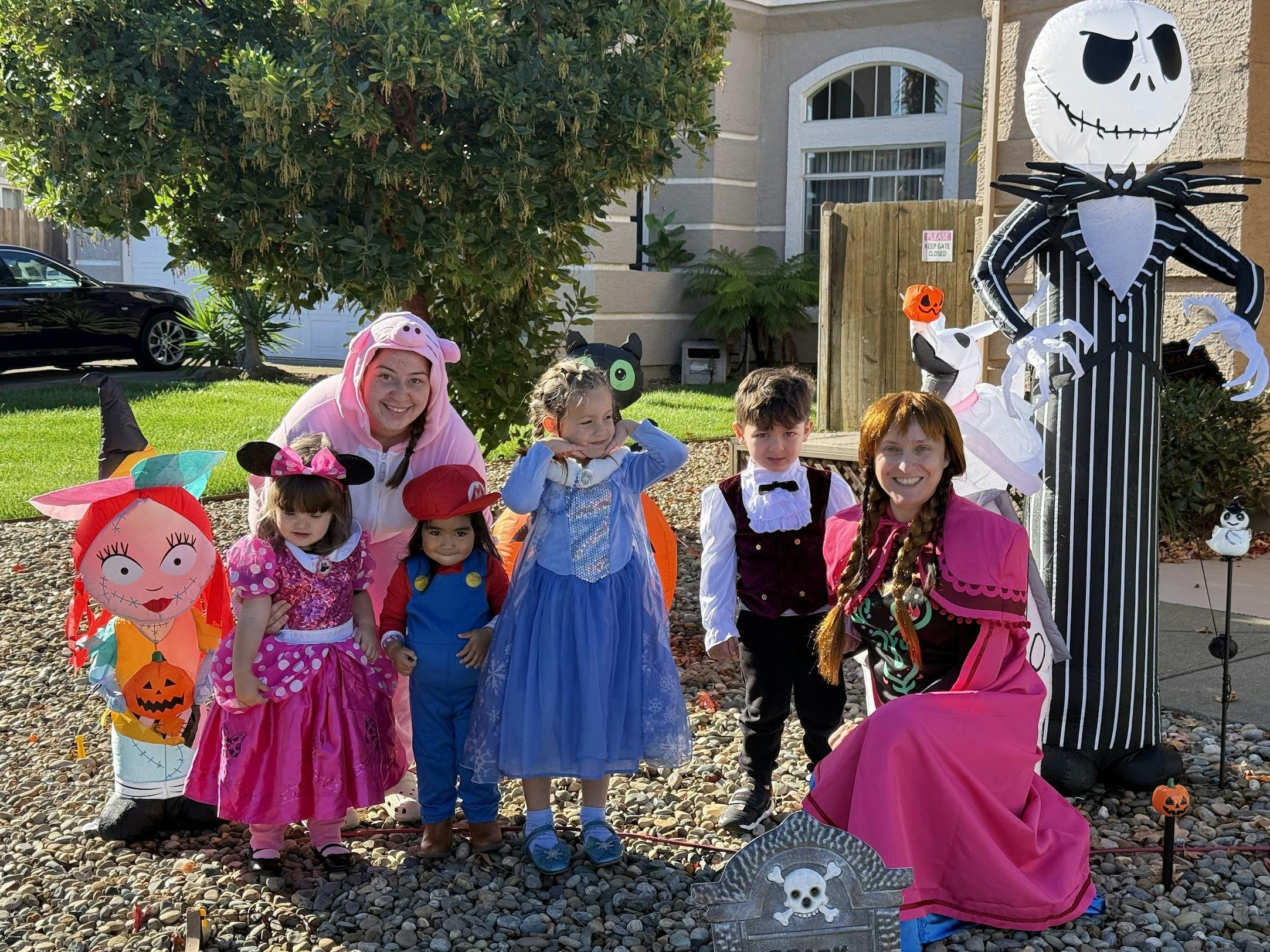 People and children in Halloween costumes with large inflatables