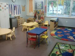 Preschool classroom with small tables and chairs