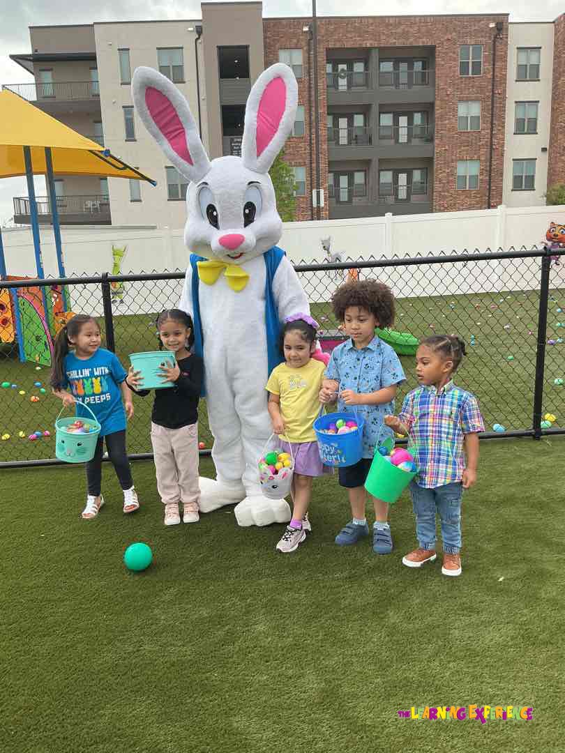 People in an Easter Bunny costume with four children holding buckets