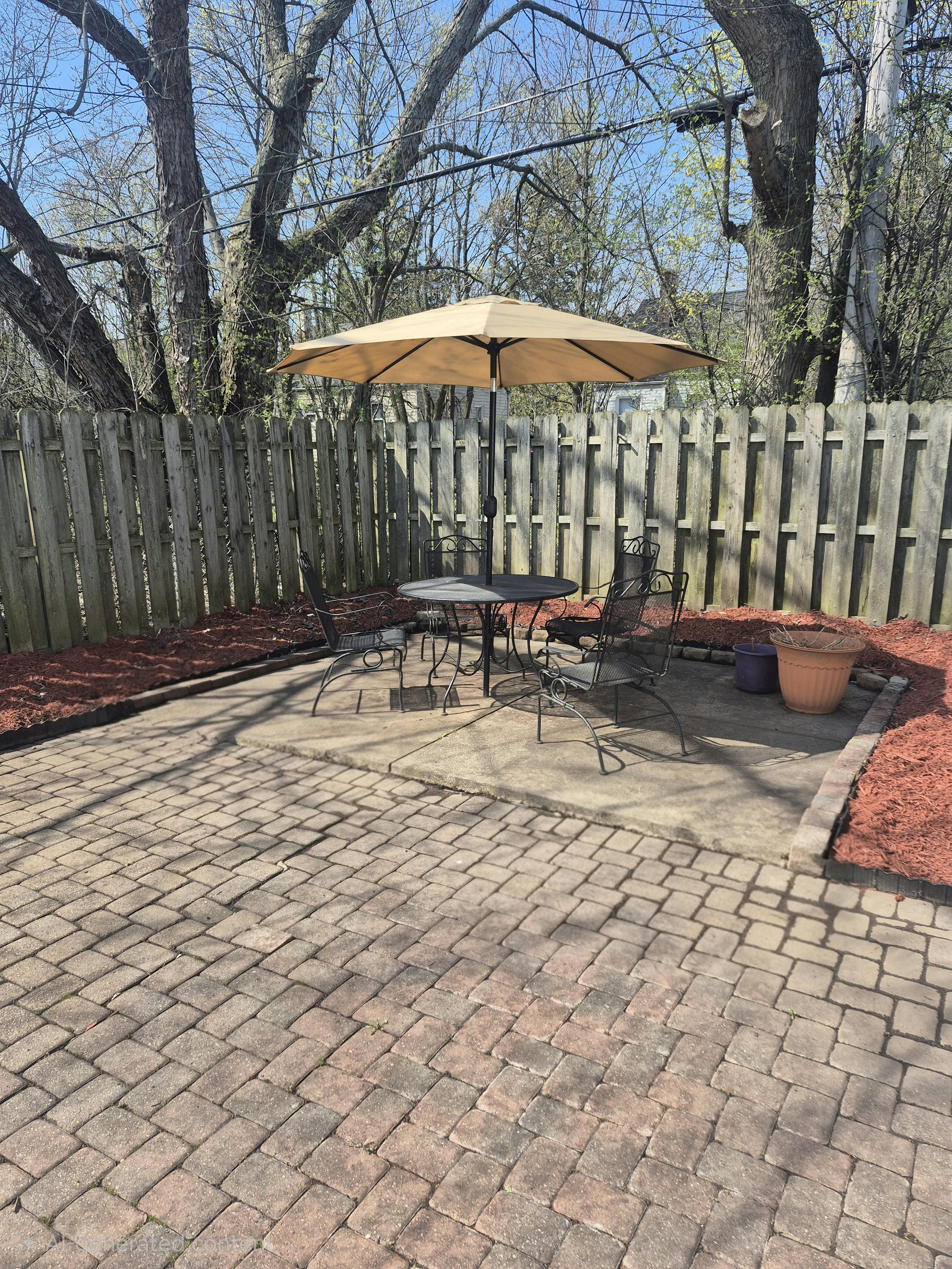Patio with a table, chairs, and umbrella